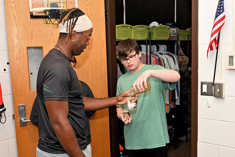 adult and student making coffee drink