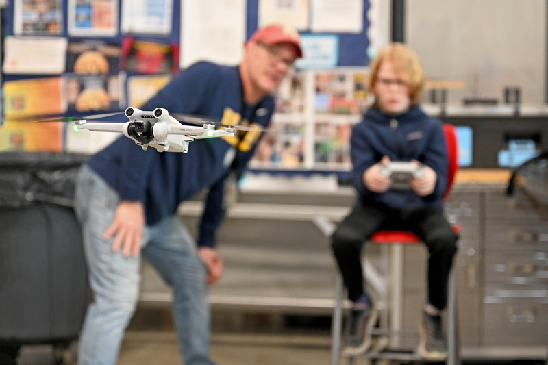 student flying drone