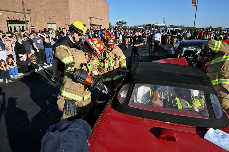firefighters working on simulated car accident