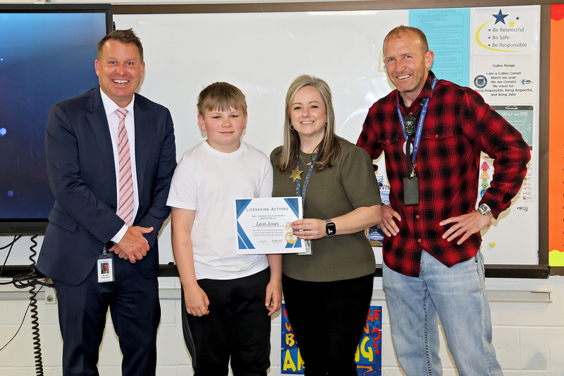 Three adults and a studet with a certificate
