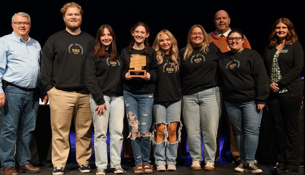 people smiling with award