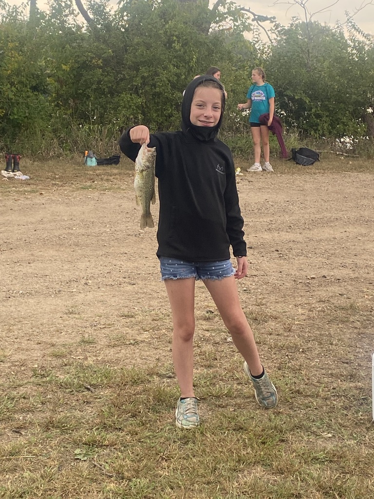 7th grade student holding a fish