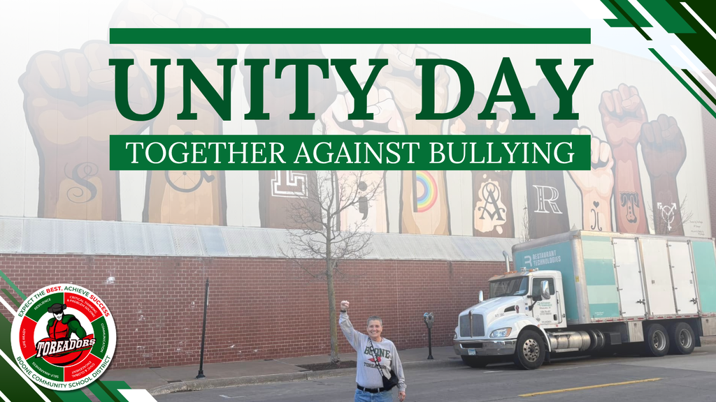 A graphic shows a person standing on a street with their fist raised in front of a mural of raised fists representing unity and diversity. Green text across the top reads “Unity Day” and below it “Together Against Bullying.” The Boone Community School District Toreadors logo appears in the bottom left corner.