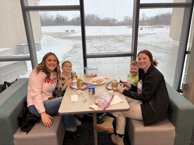 Preschool students building gingerbread houses