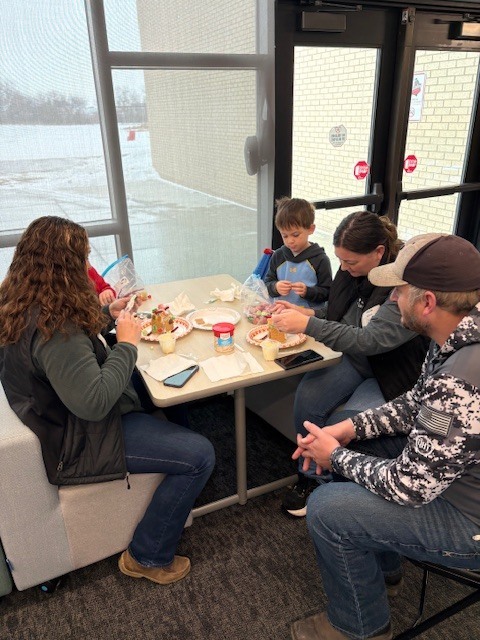 Preschool students building gingerbread houses