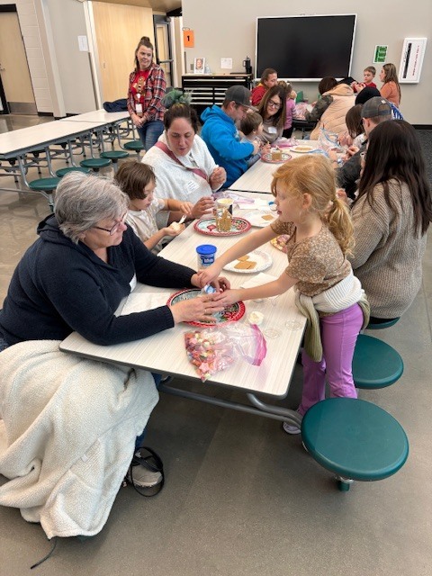 Preschool students building gingerbread houses