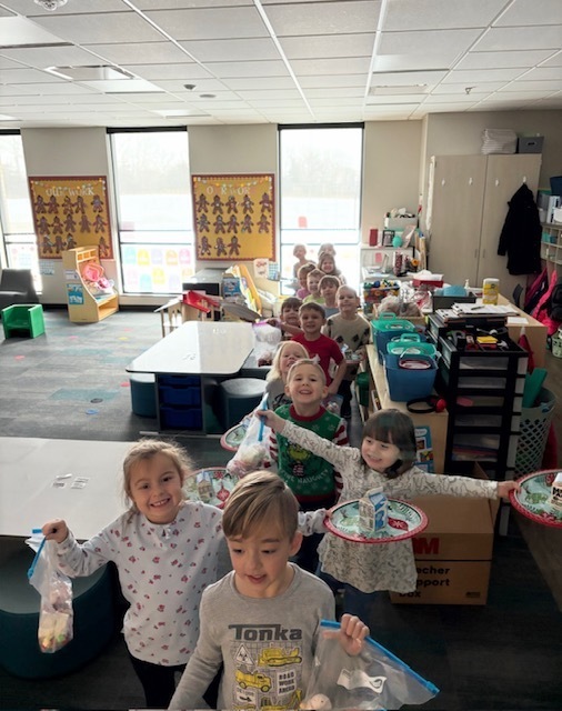 Preschool students with their gingerbread houses