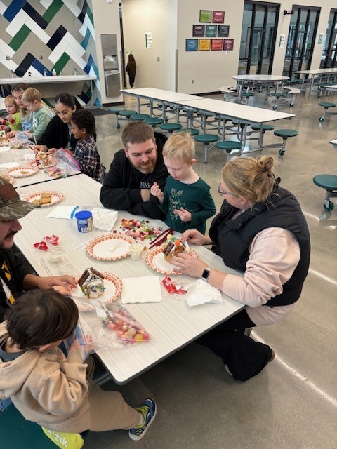 Preschool students building gingerbread houses