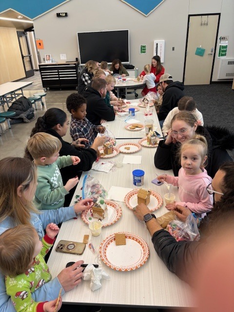 Preschool students building gingerbread houses