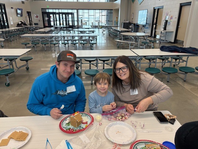 Preschool students building gingerbread houses