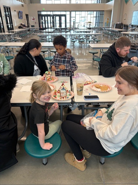 Preschool students building gingerbread houses