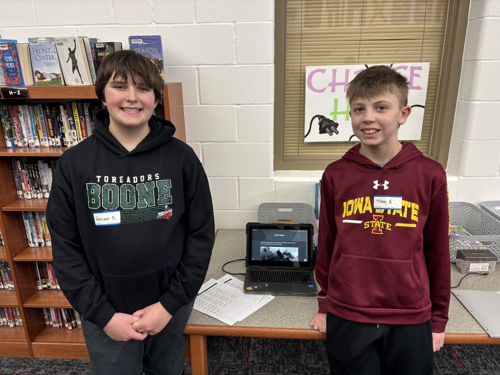 two 6th grade Excel students standing together for their research project