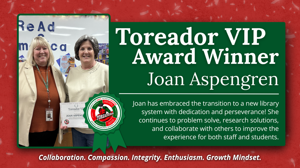 Two women stand together, one holding a certificate for the Toreador VIP Award presented to Joan Aspengren for dedication to improving the library system.
