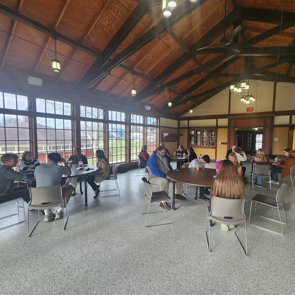 Students in the Rising Leaders Academy sitting at round tables