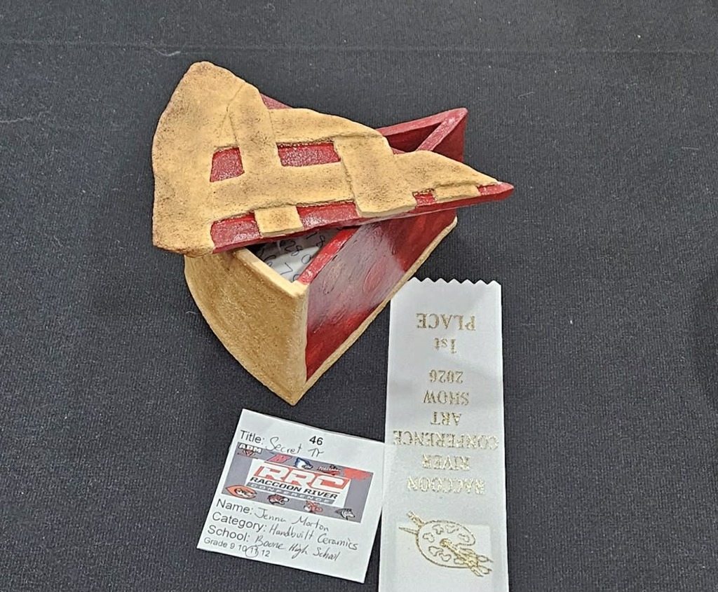 Clay dish shaped and painted like a piece of pie.