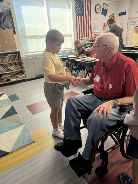 Declan shakes Mr. Zink's hand