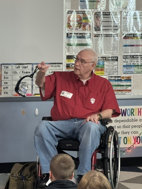 Mr. Zink shows a device that helps him carry a drink without spilling, even if he uses his cane