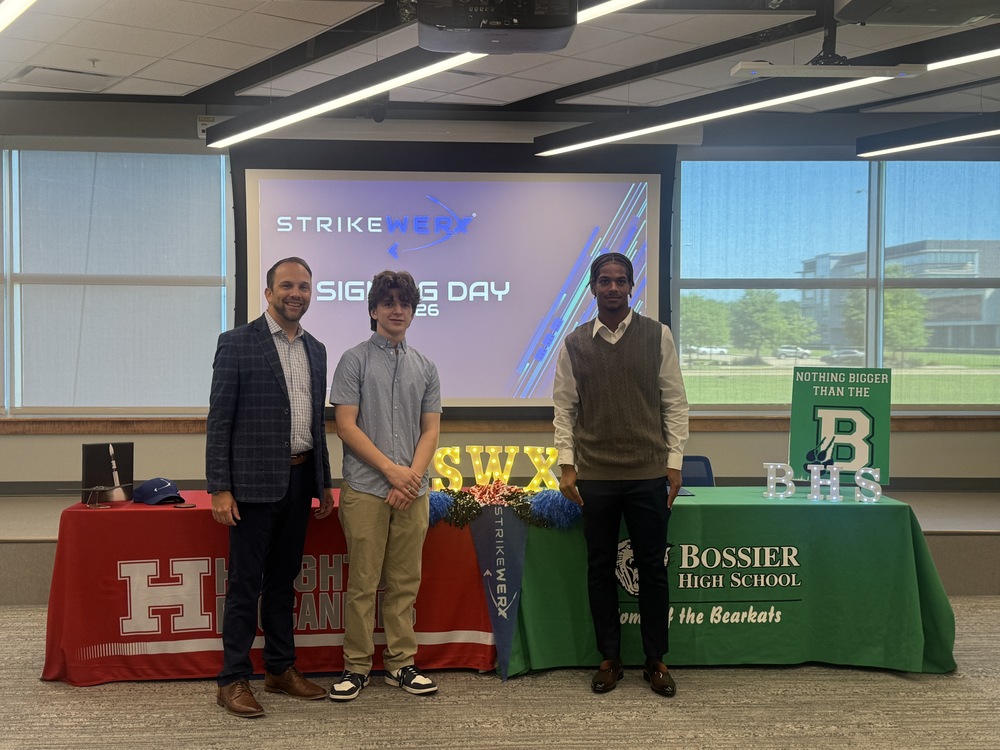 Photo of CIC President Kevin Nolten next to Charly McAnn and Quinton Hodge during Signing Day at STRIKEWERX