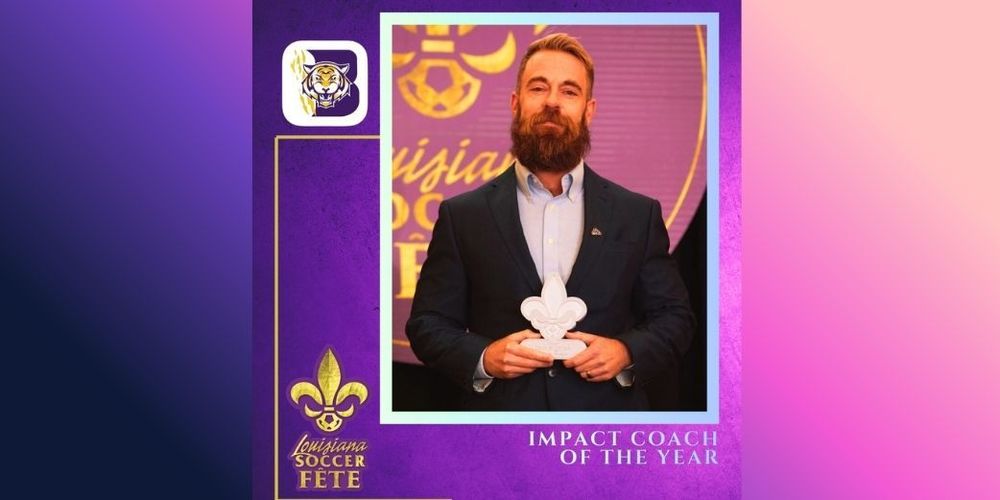 Coach Jesse Dyer, Impact Coach of the Year, holding a fleur de lis award