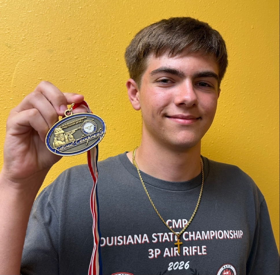Photo of Chris Fick holding a National  Championship medal