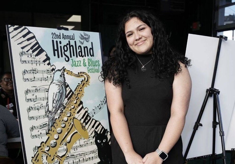 Photo of Sara Villarrial standing in front of her winning poster design
