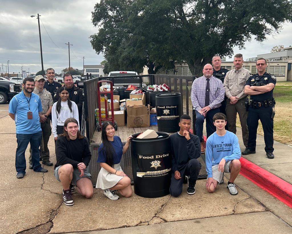 Airline students posing with Food Drive Bucket and donations