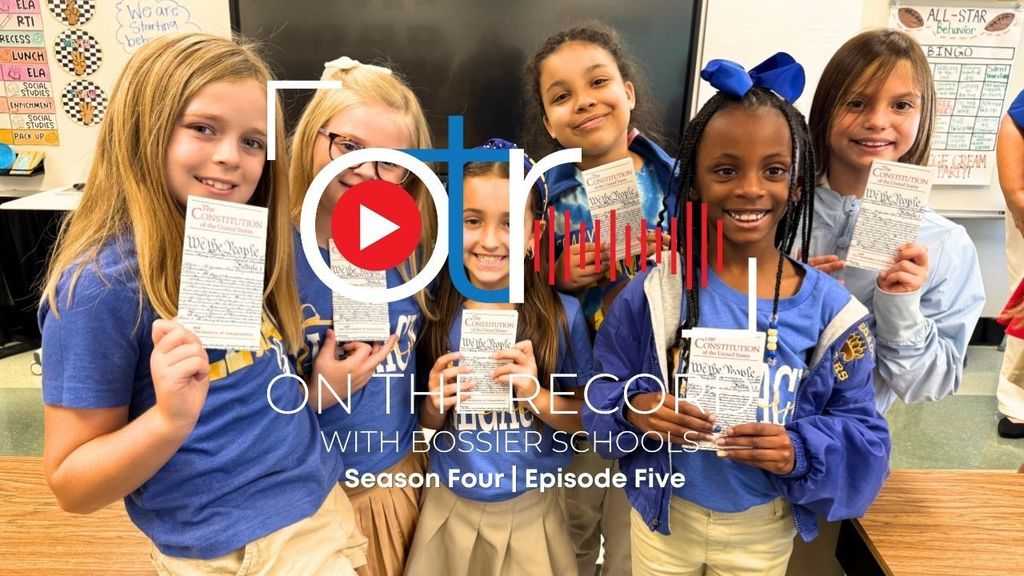 six Legacy  Elementary students proudly show off their Constitution booklets.