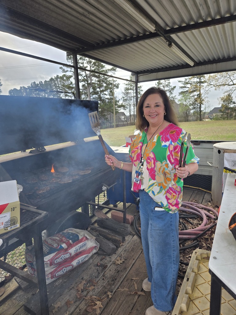 Mrs. Cockerell grilling burgers