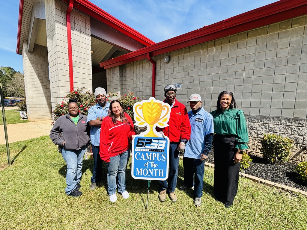 Haughton Elementary custodial crew poses in front of the school with their Campus of the Month award
