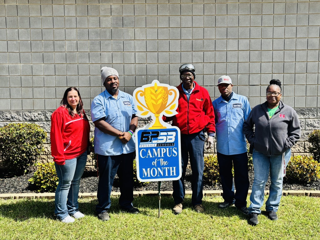 Haughton Elementary custodial crew poses in front of the school with their Campus of the Month award