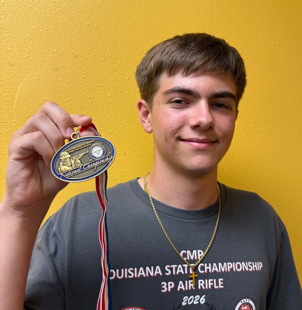 Chris Fick poses with his National Championship Medal