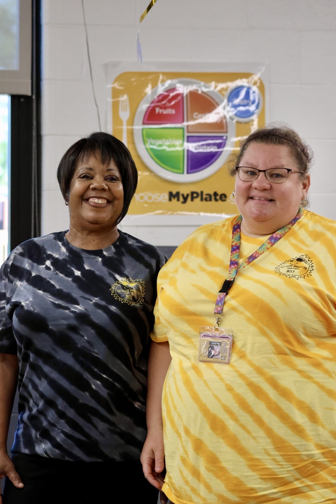 Lunch ladies in their yellow and black tye dye shirts