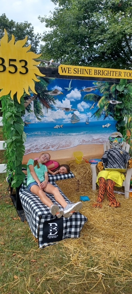 students laying at the tiger scarecrow