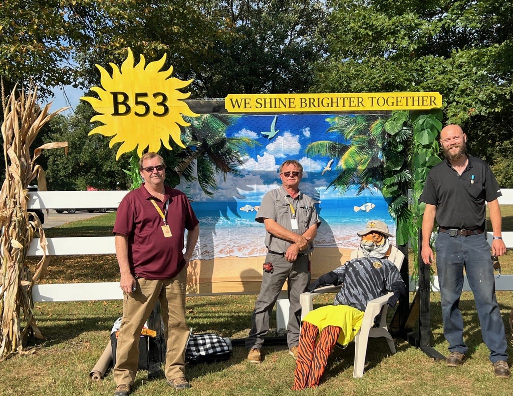 our 3 maintenance workers setting up the tiger scarecrow