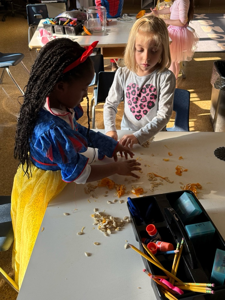 2 students counting pumpkin seeds 