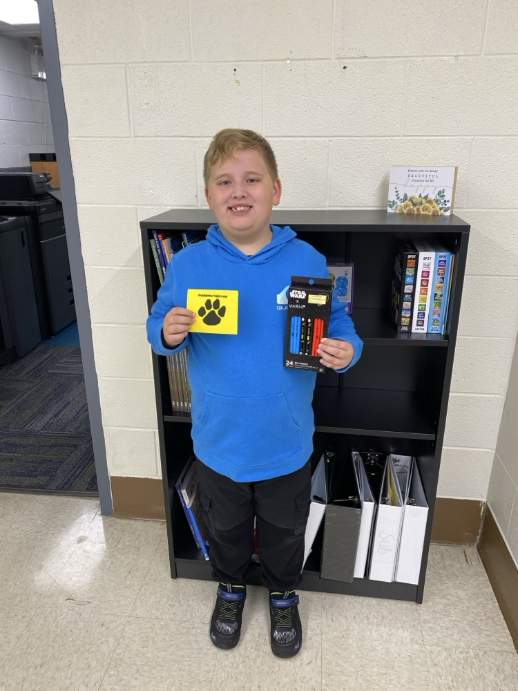 student with golden Tiger paw and prize 