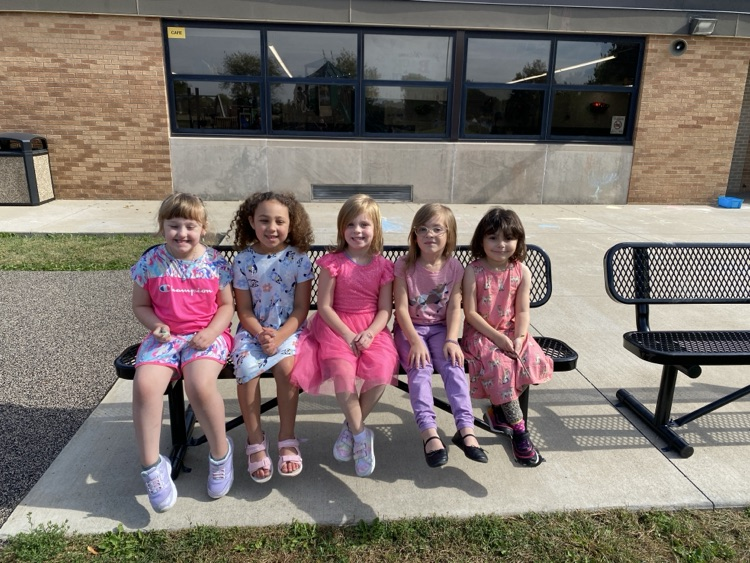 kids sitting on a park bench 
