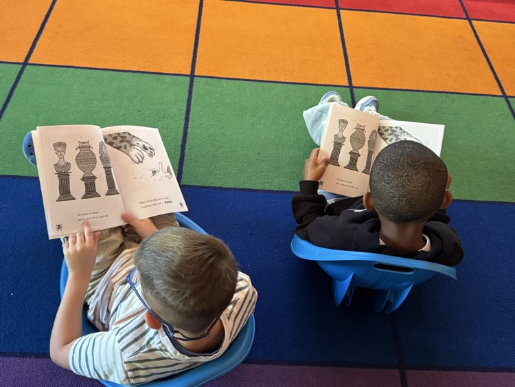2 students in rocker chairs reading