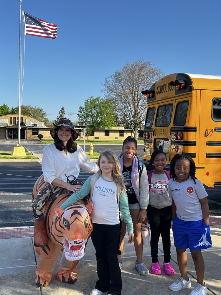 students with principal in a costume