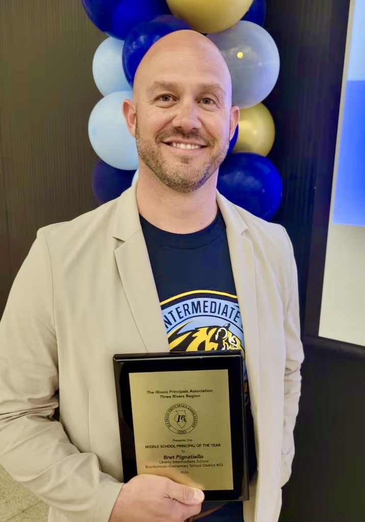 Principal of Liberty Mr. Bret Pignatiello holding Principal; of the Year award