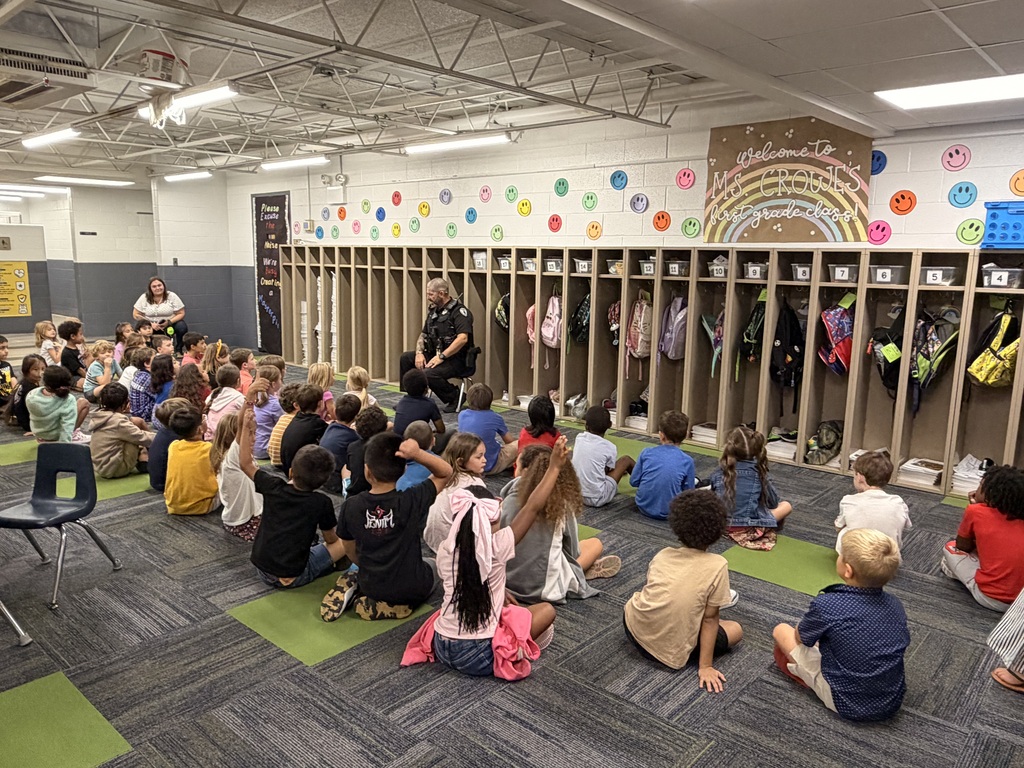 kids sitting in the commons area listening to officer andy