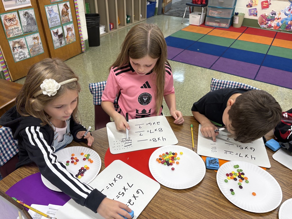 3 students working with Skittles at the table