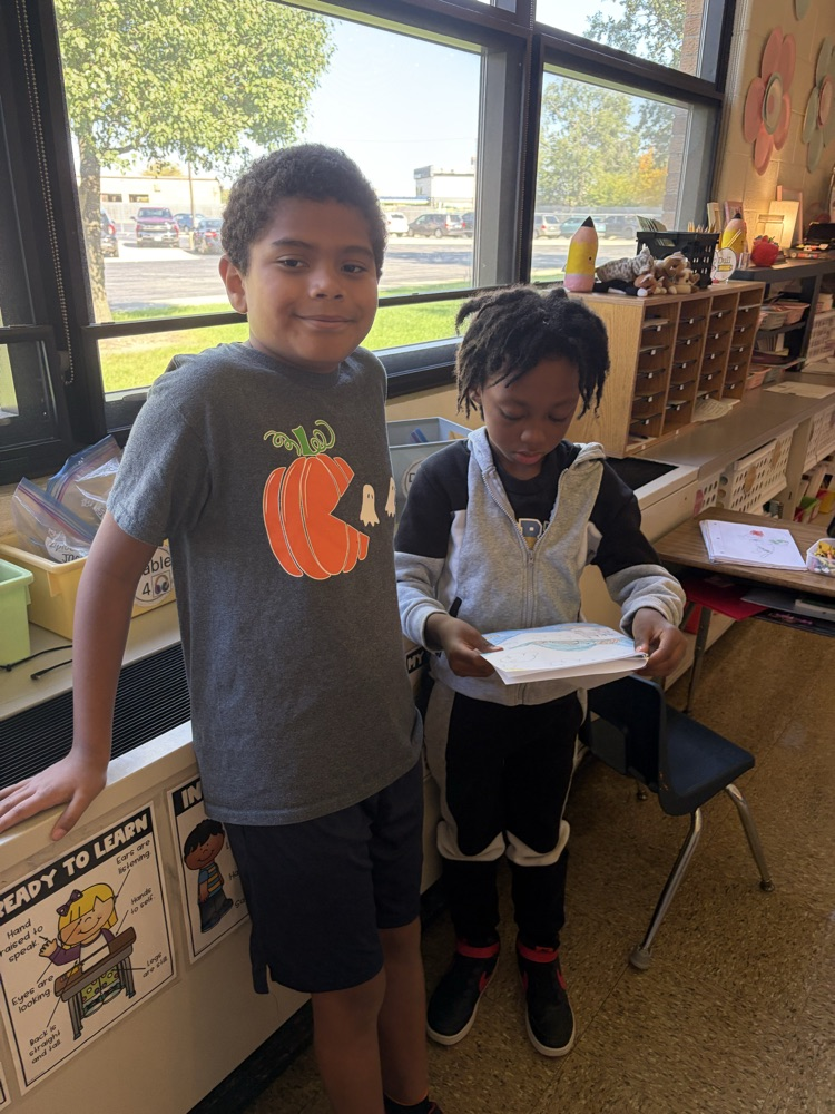 two students reading essays