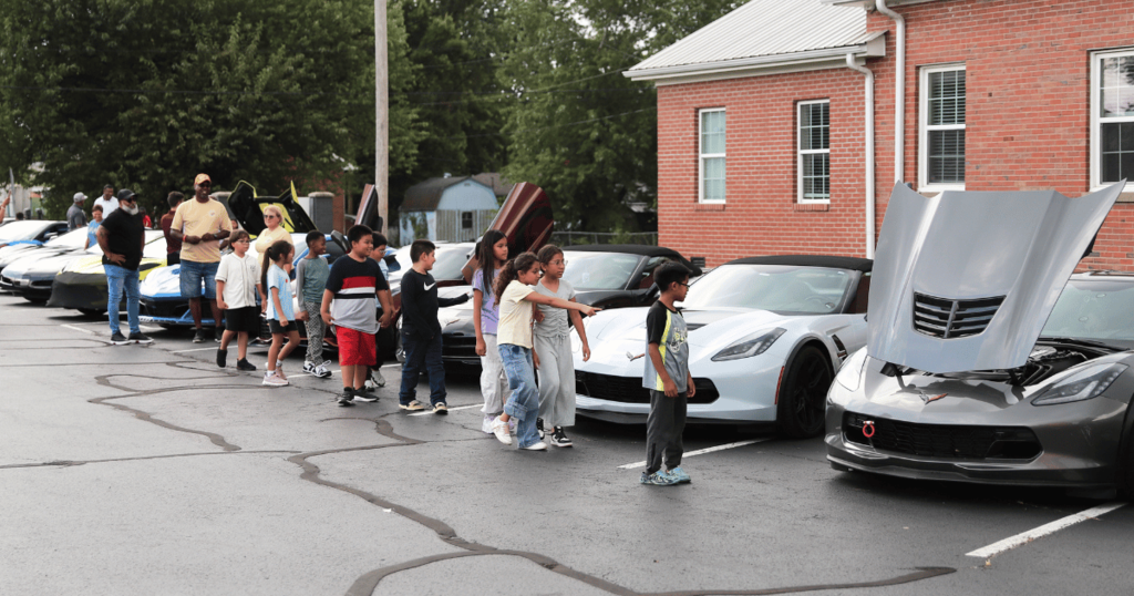 Students looking at CACW Corvettes