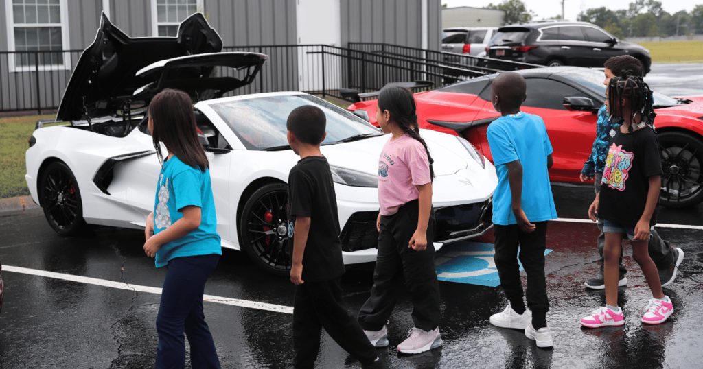 Students looking at CACW Corvettes