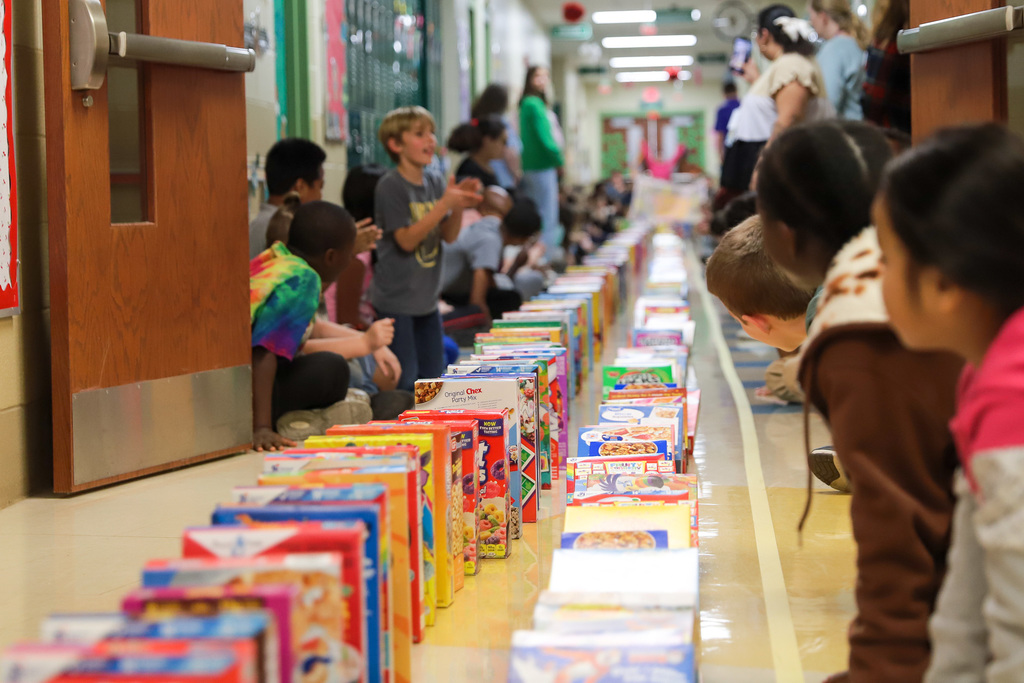 students cheer for cereal domino