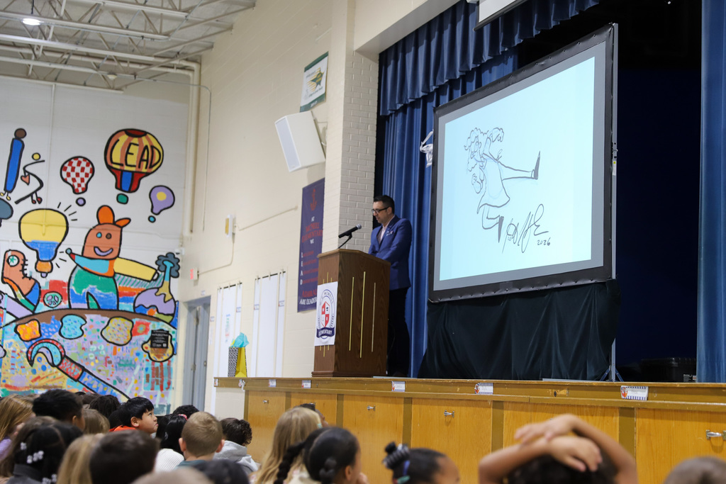 Jarrett J. Krosoczka draws for students at McNeill Elementary