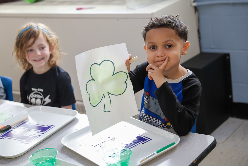 Student showing shamrock artwork