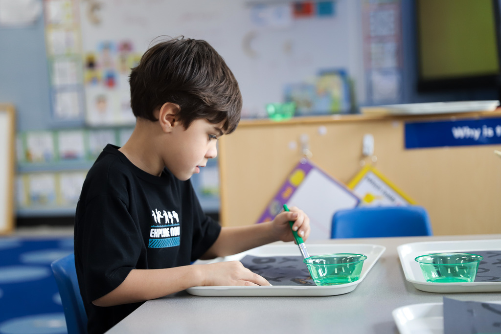 Student painting with water