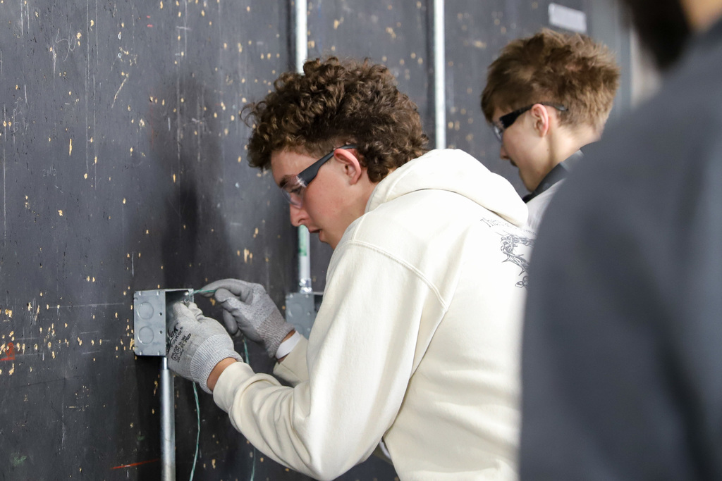 Students participating in the wire pull competition at M&L Electrical